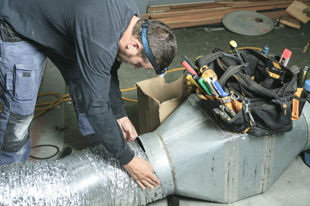 a ventilation cleaner checks for dust.